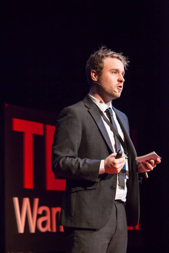 Jamie Bykov-Brett delivering a talk on stage